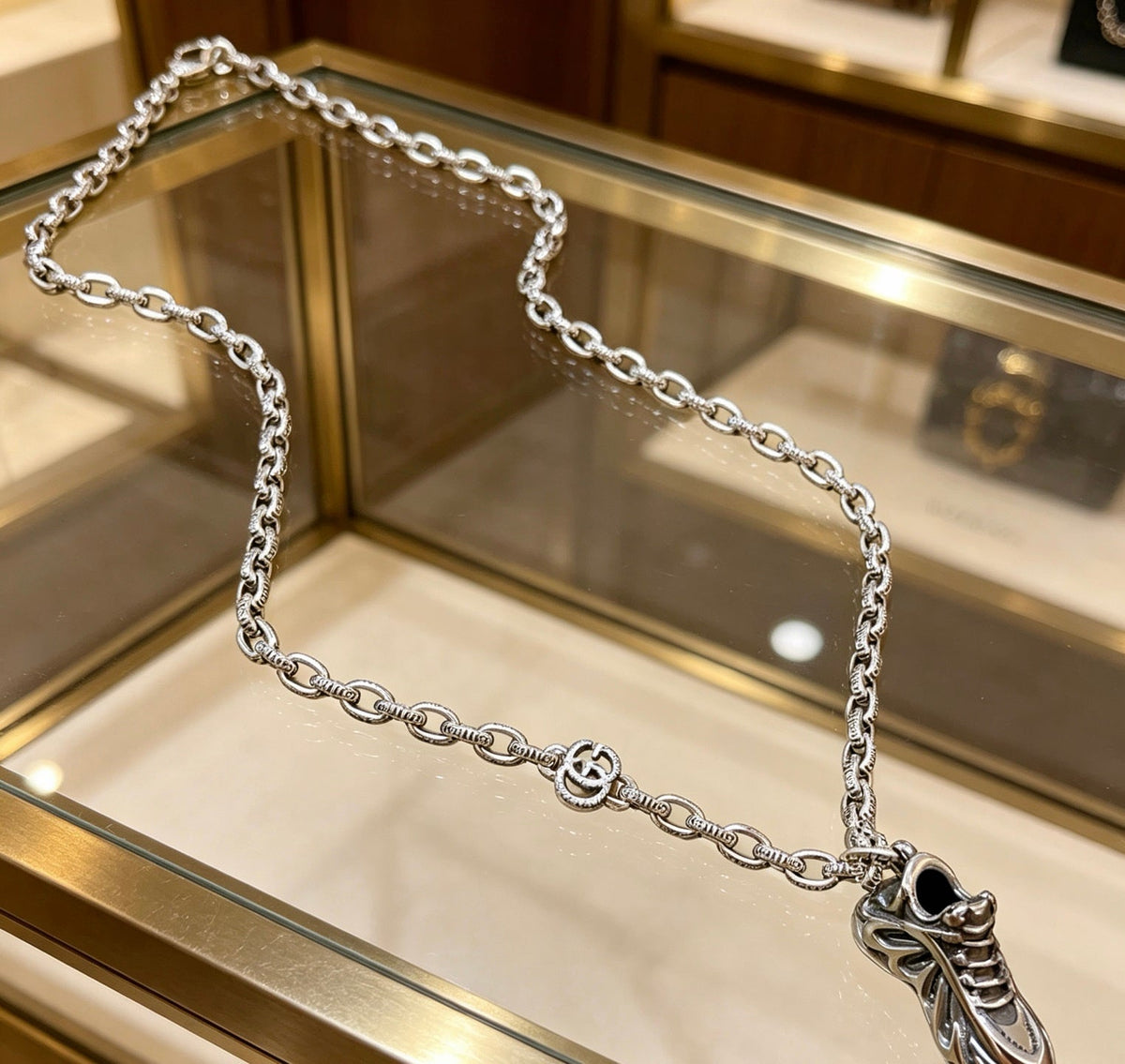 Martin Graham pendant necklace in polished metal-tone – close-up detail