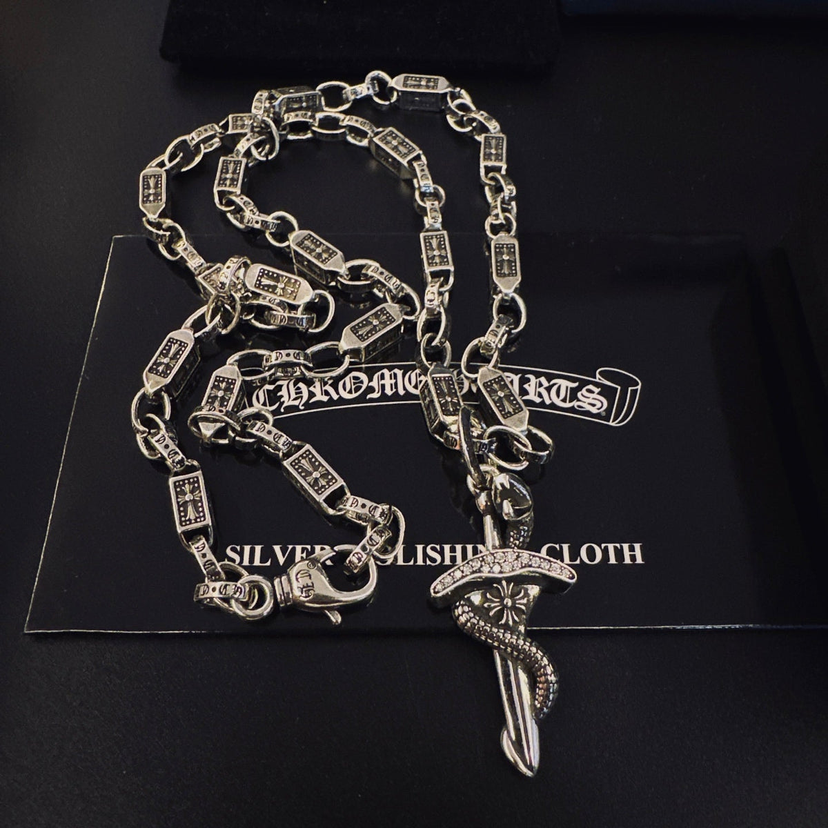 Martin Graham pendant necklace in polished metal-tone – close-up detail