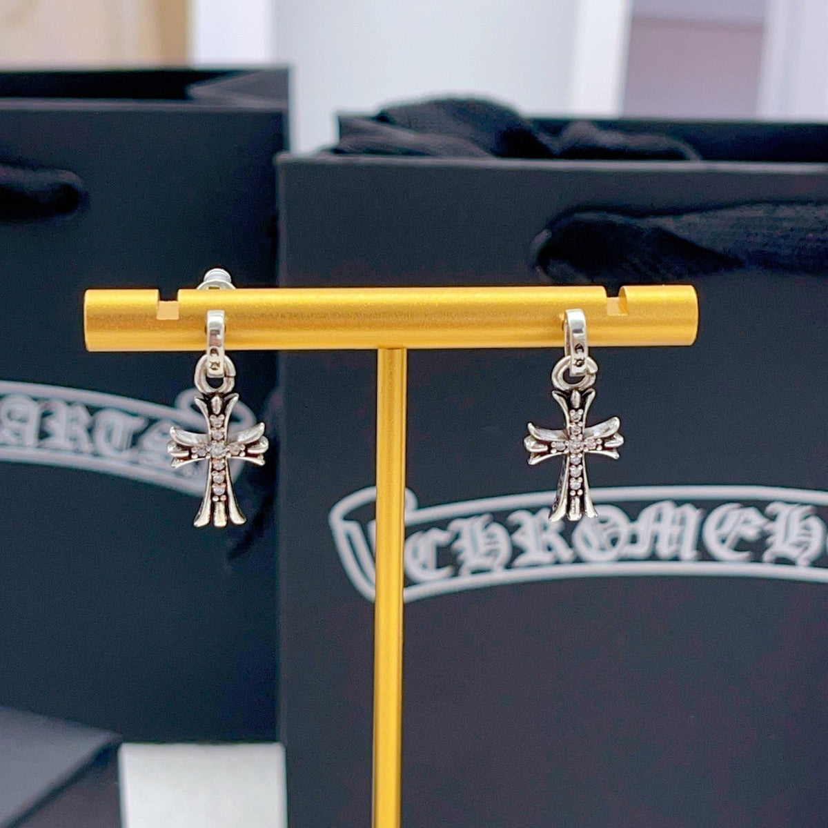 Martin Graham stud earrings in polished metal-tone – close-up detail