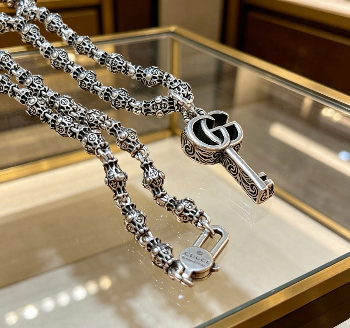 Martin Graham pendant necklace in polished metal-tone – close-up detail
