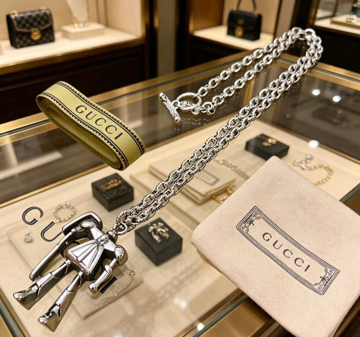 Martin Graham pendant necklace in polished metal-tone – close-up detail