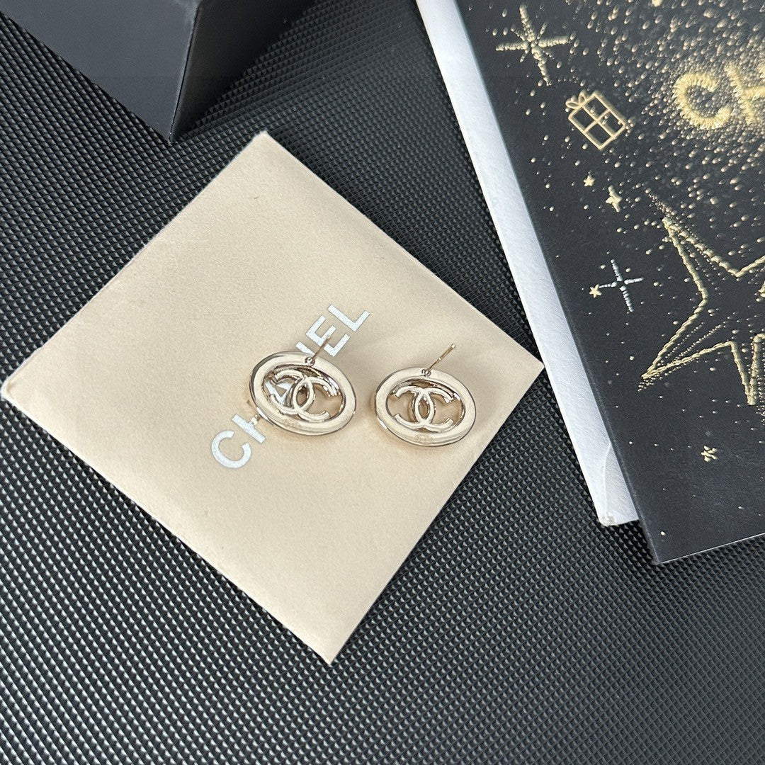 Martin Graham stud earrings in polished metal-tone – close-up detail