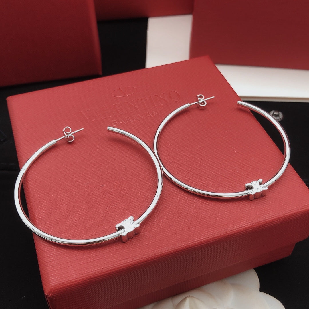 Martin Graham earrings in polished metal-tone