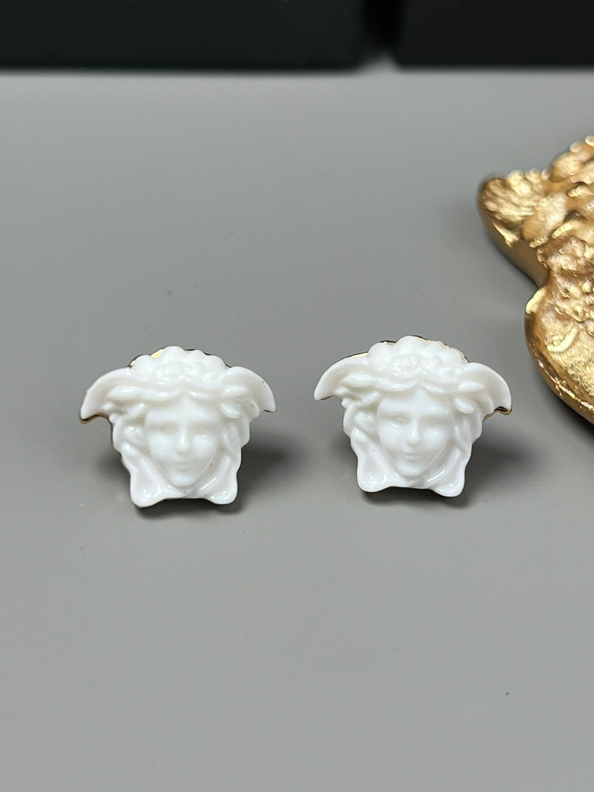 Martin Graham stud earrings in polished metal-tone – styled product view
