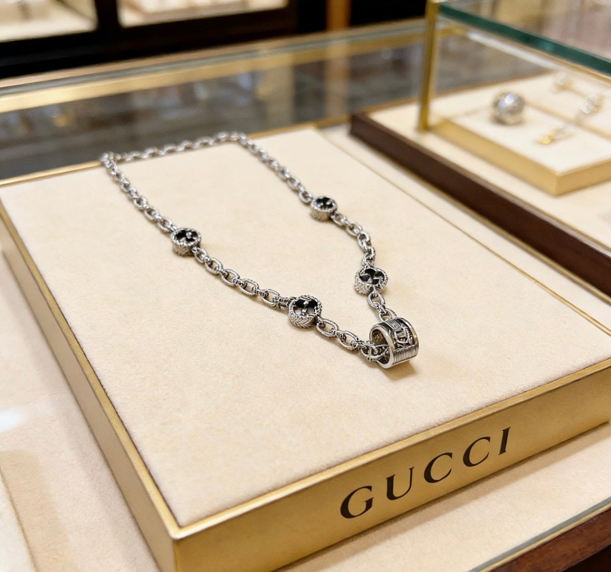 Martin Graham pendant necklace in polished metal-tone – close-up detail