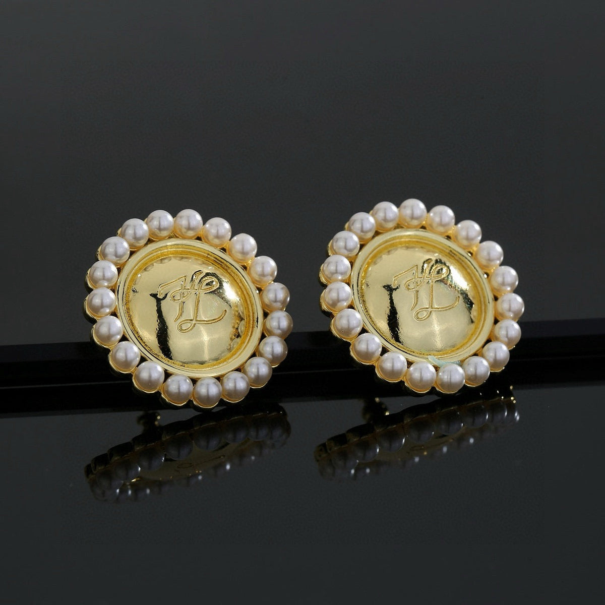 Martin Graham stud earrings in polished metal-tone