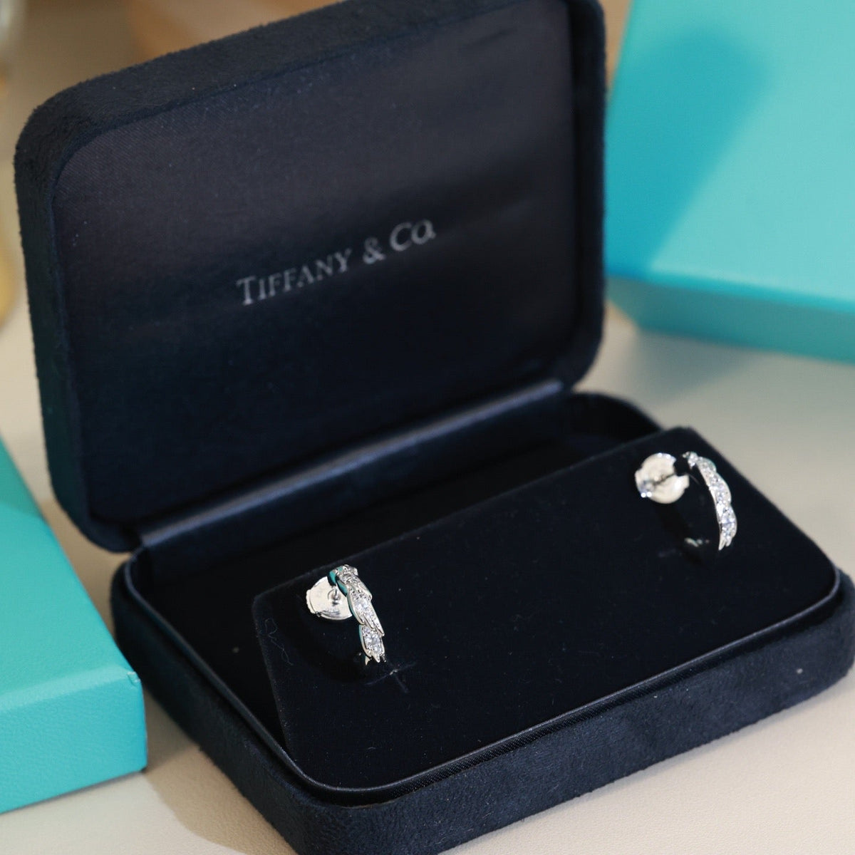Martin Graham stud earrings in polished metal-tone – close-up detail