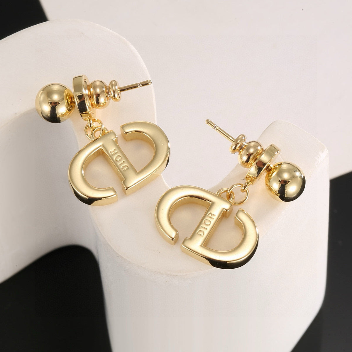 Martin Graham stud earrings in polished metal-tone – close-up detail