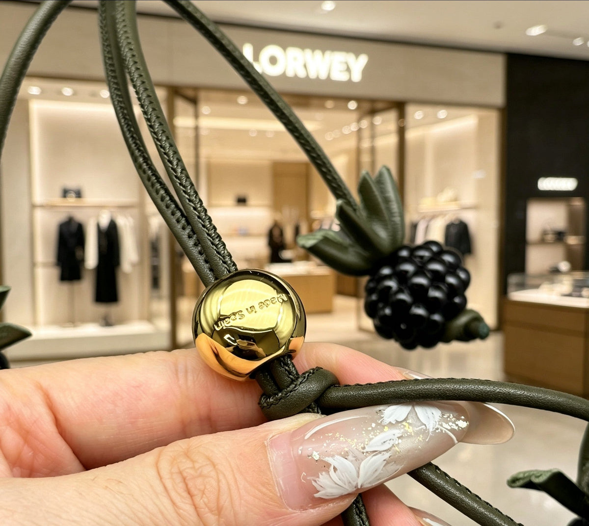 Martin Graham bag charm in polished metal-tone – close-up detail
