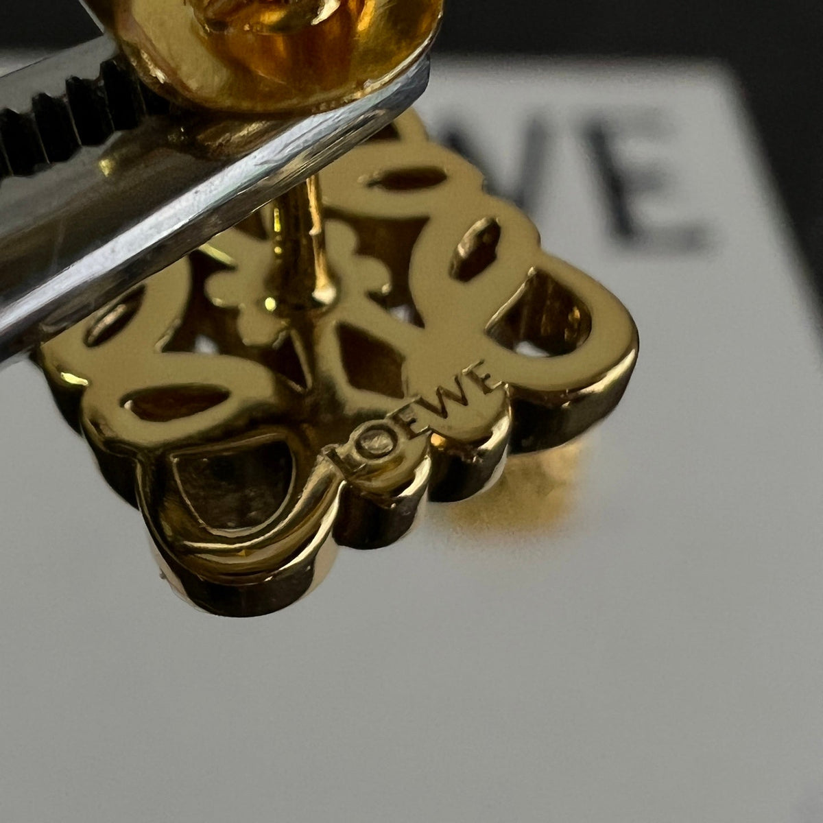 Martin Graham stud earrings in polished metal-tone – close-up detail