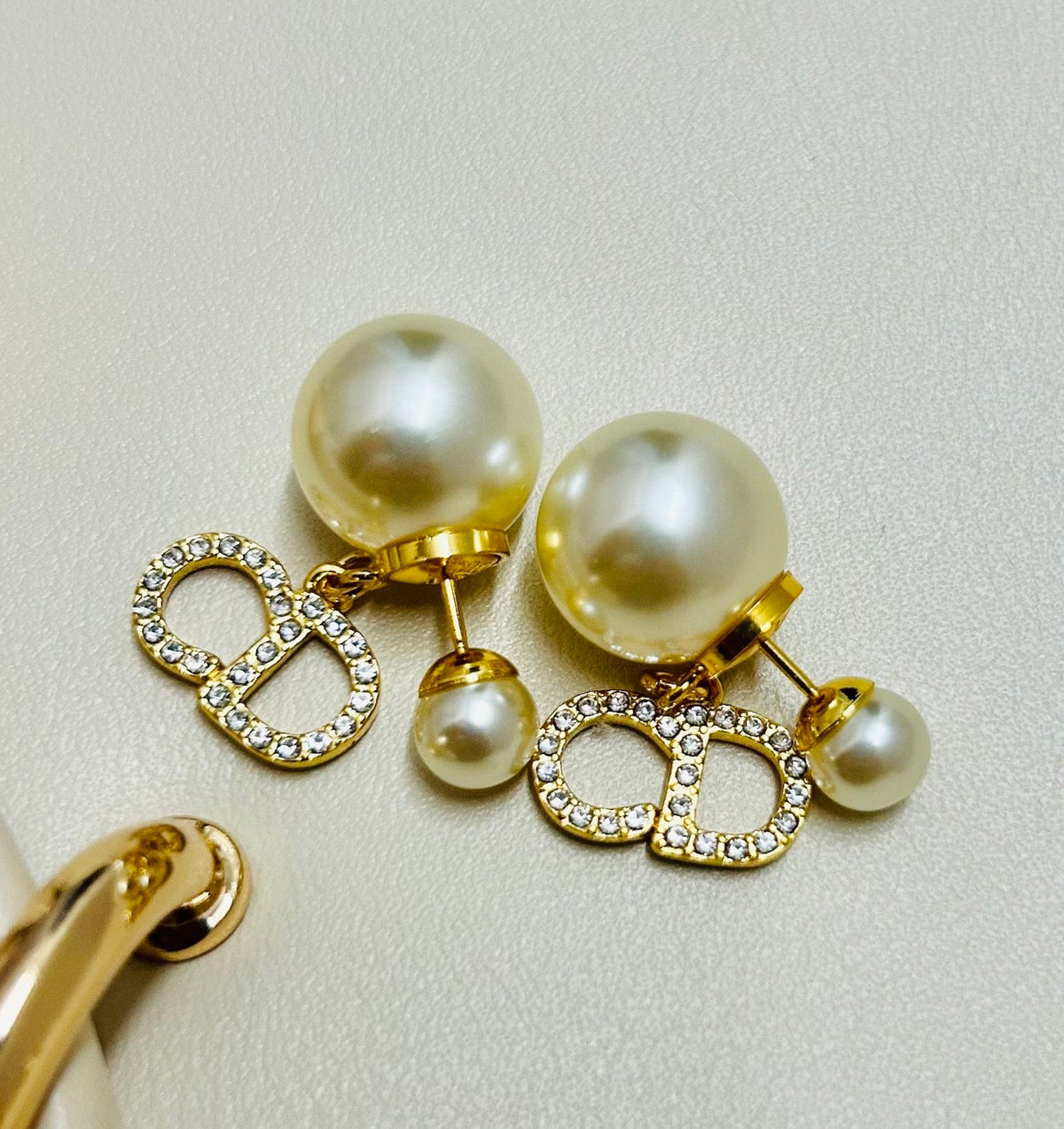 Martin Graham earrings in polished metal-tone – close-up detail