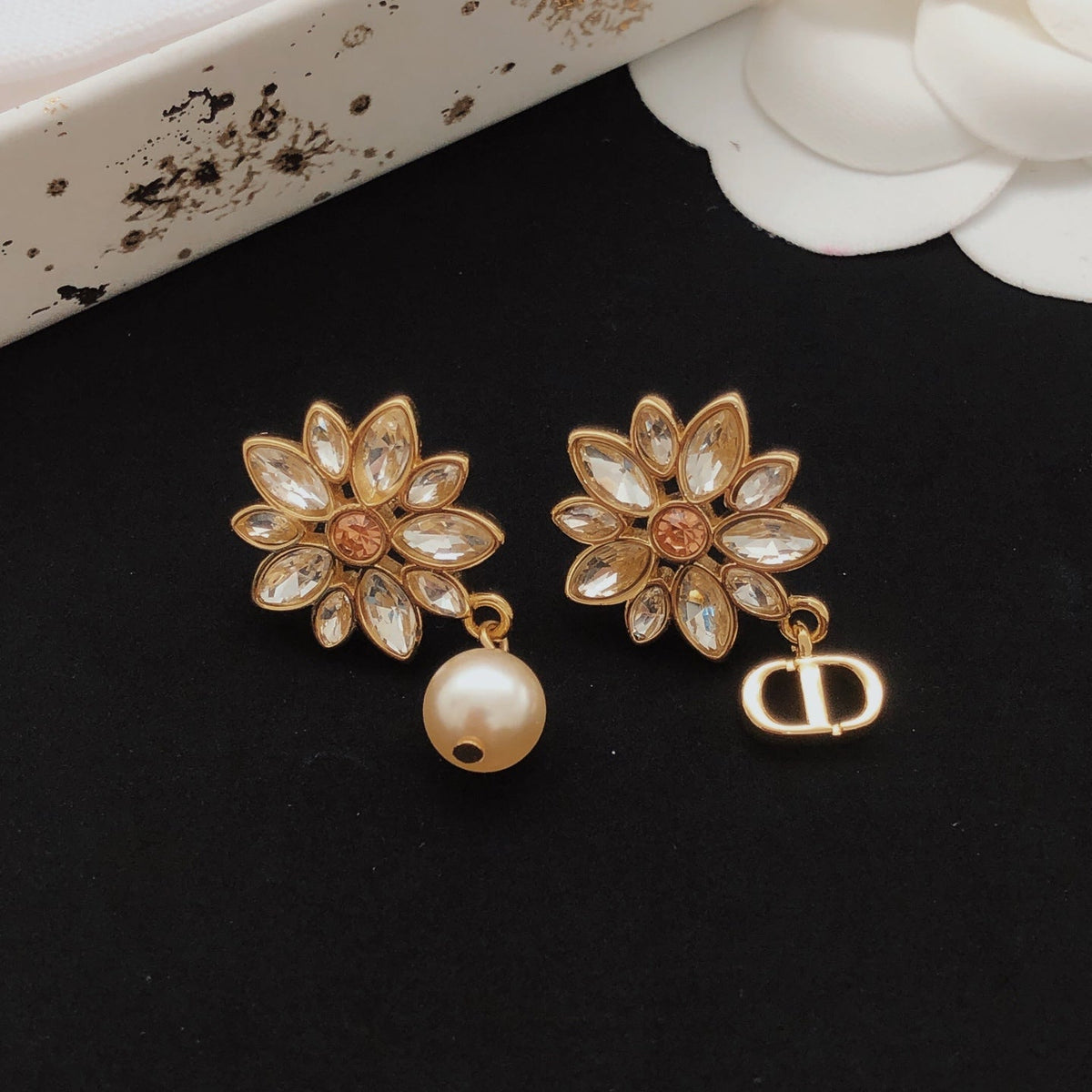 Martin Graham stud earrings in polished metal-tone – close-up detail