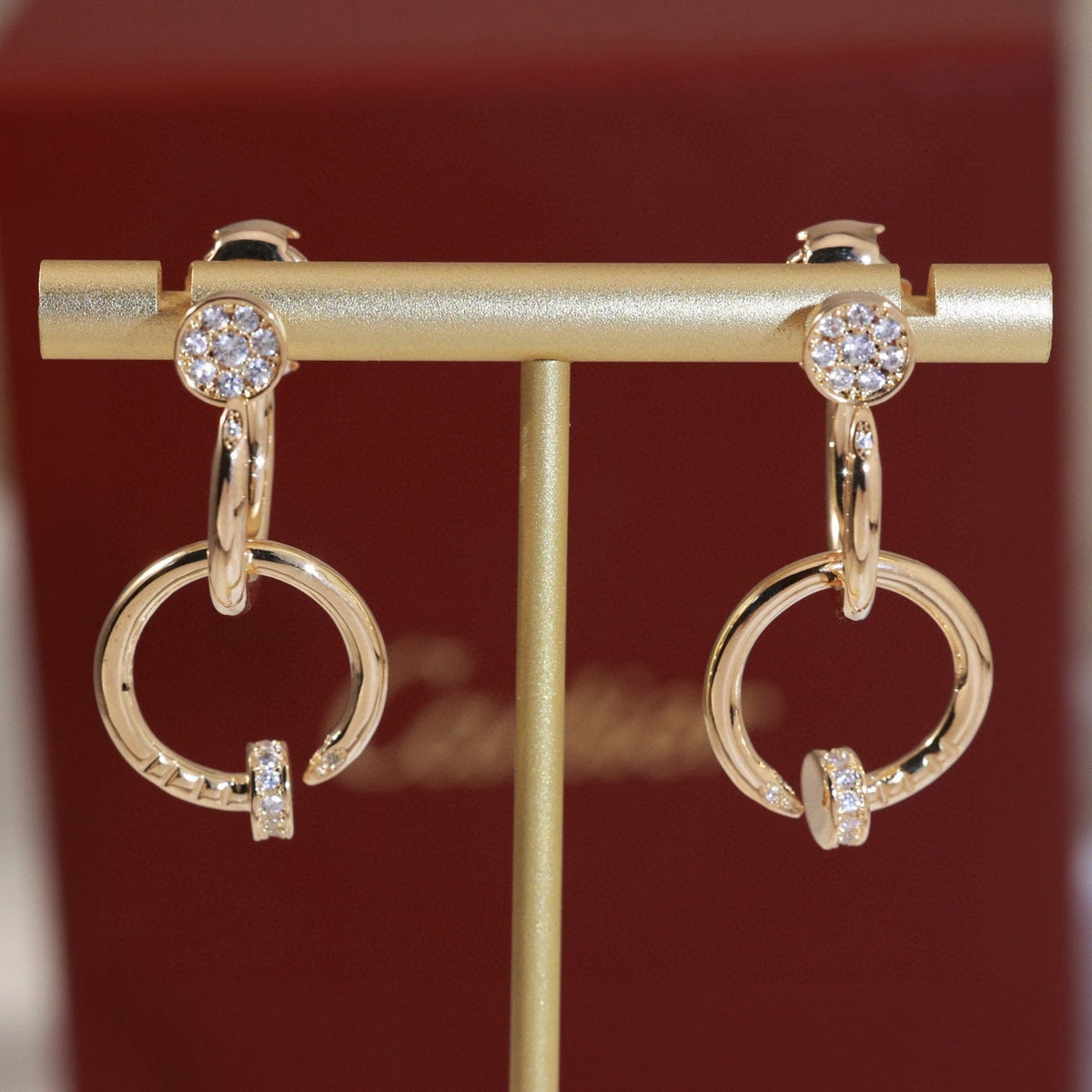 Martin Graham stud earrings in polished metal-tone – close-up detail