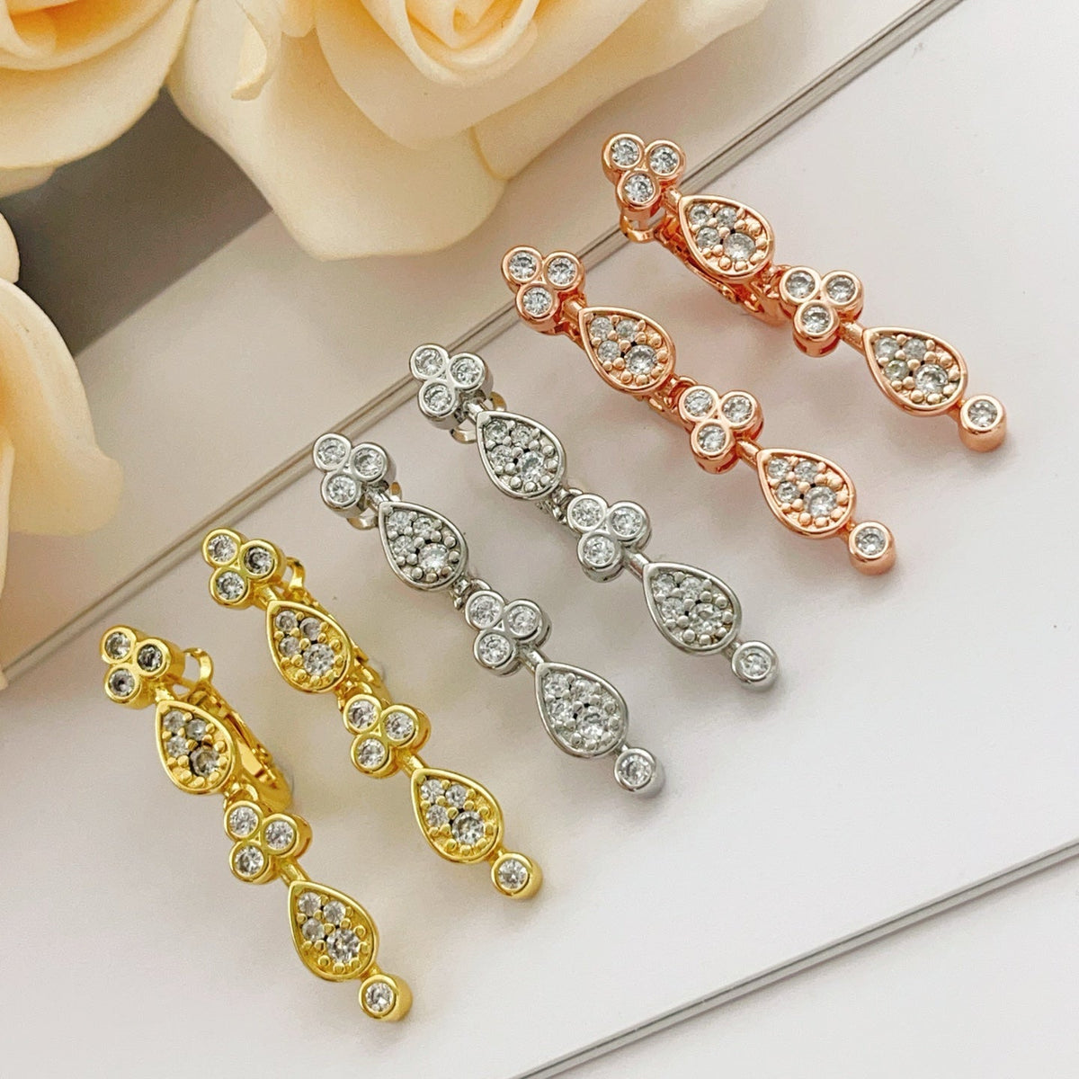 Martin Graham stud earrings in polished metal-tone – close-up detail