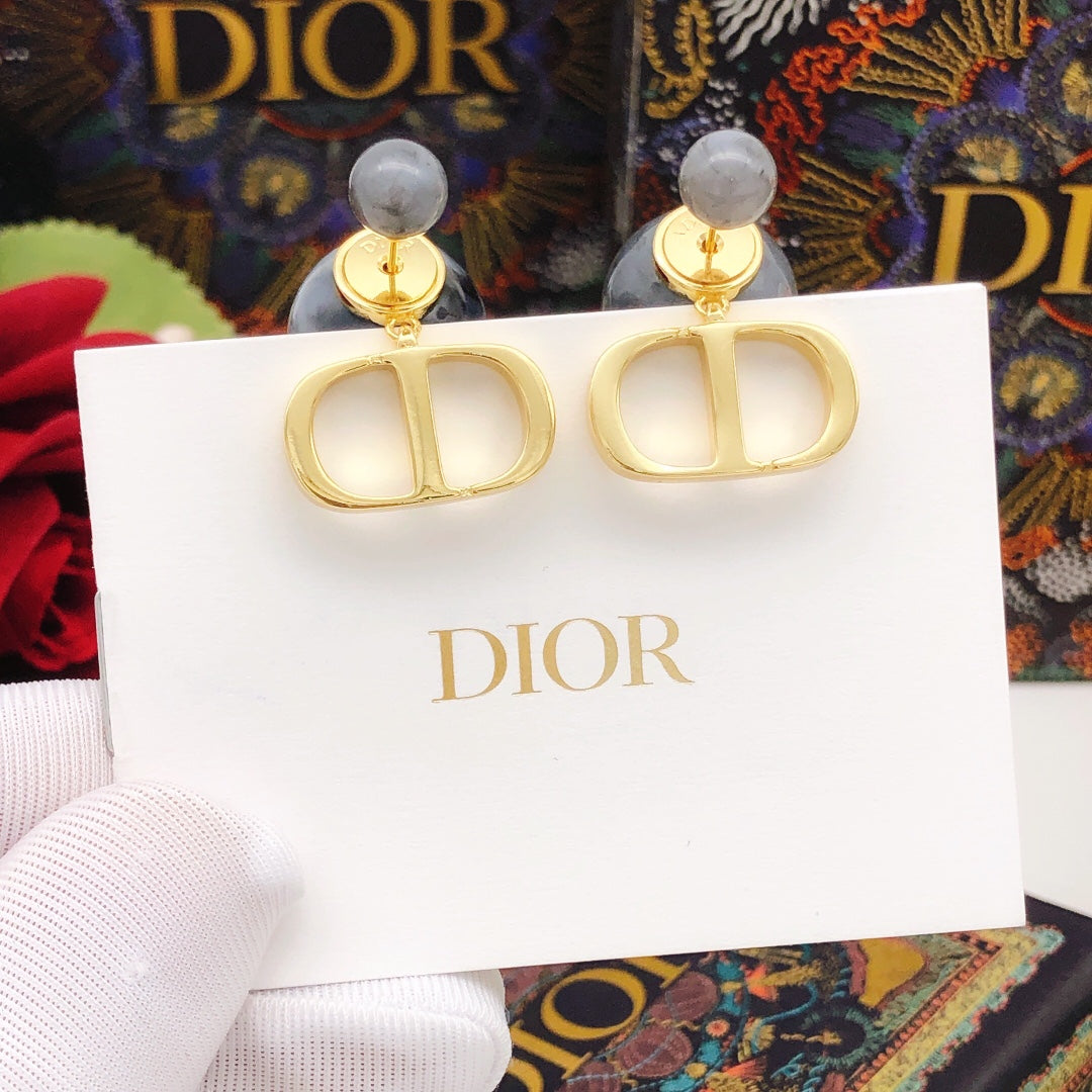 Martin Graham stud earrings in polished metal-tone – close-up detail