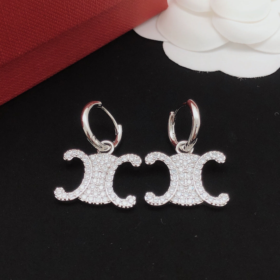 Martin Graham drop earrings in polished metal-tone