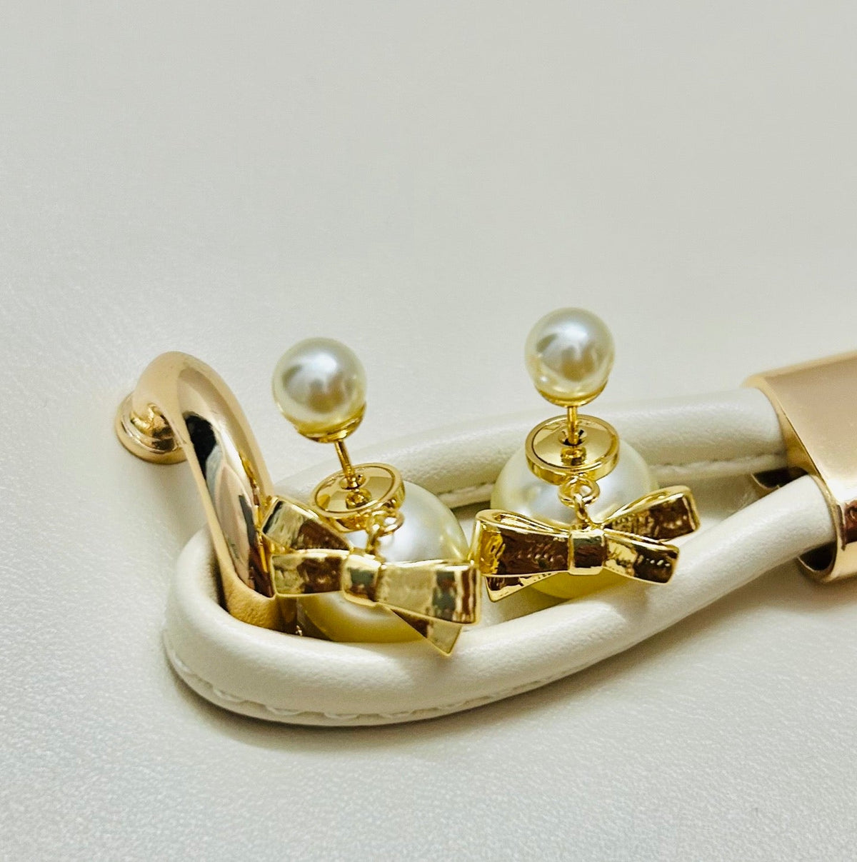 Martin Graham stud earrings in polished metal-tone – close-up detail
