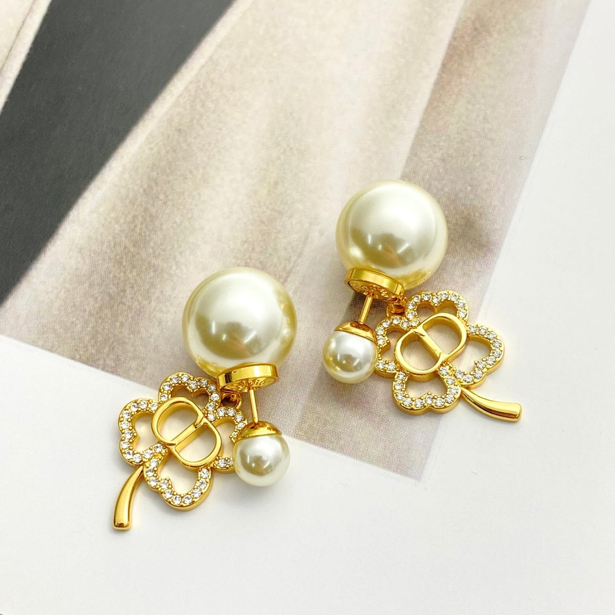 Martin Graham stud earrings in polished metal-tone – close-up detail