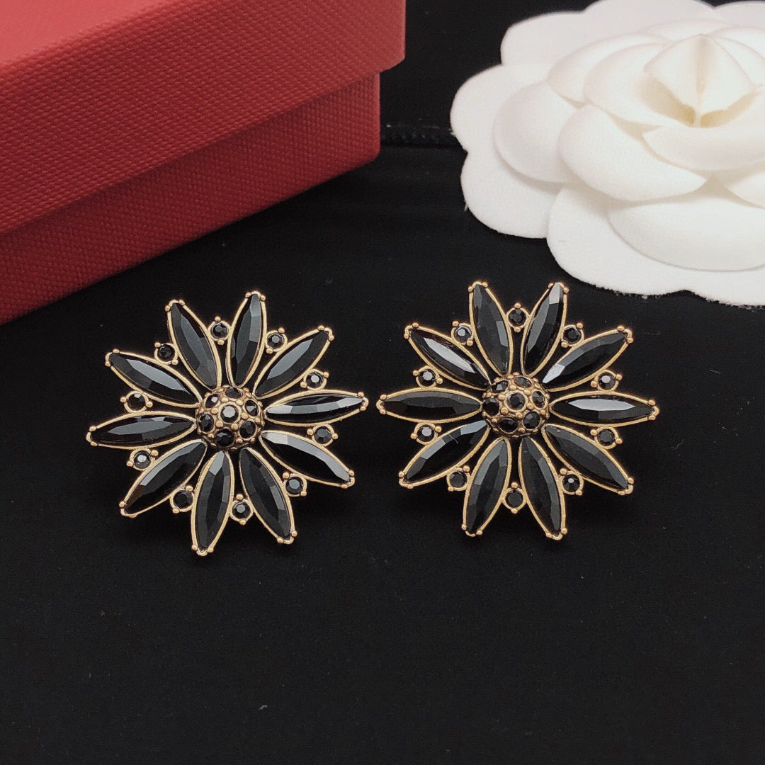 Martin Graham stud earrings in polished metal-tone – close-up detail