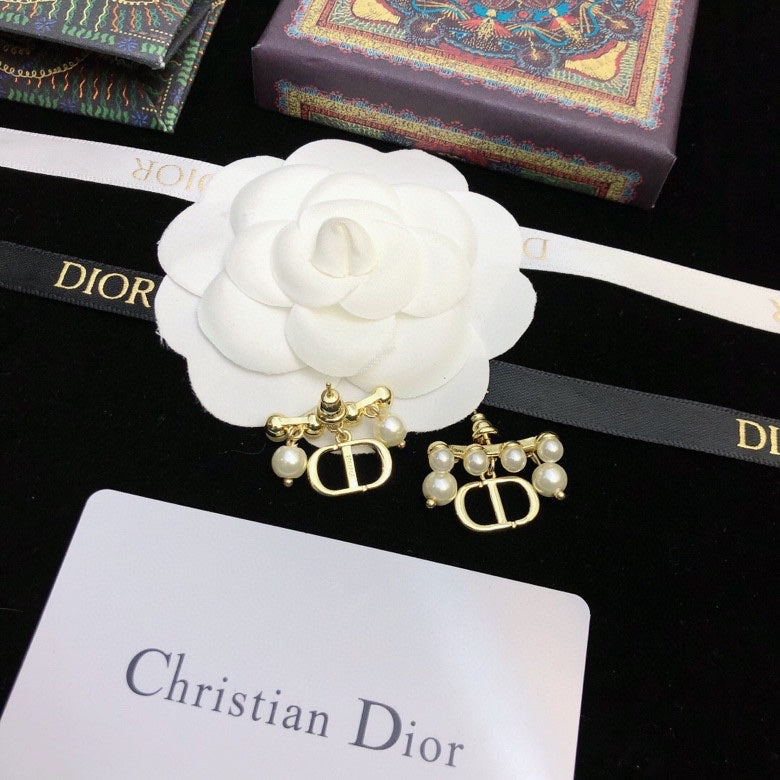 Martin Graham stud earrings in polished metal-tone – close-up detail