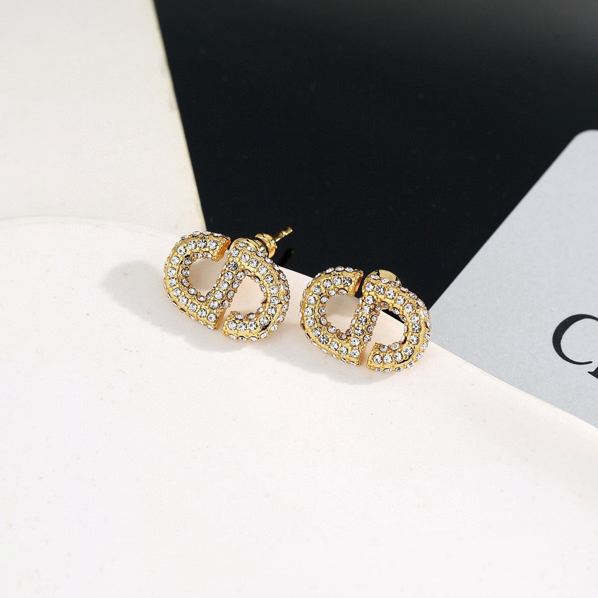 Martin Graham stud earrings in polished metal-tone – close-up detail