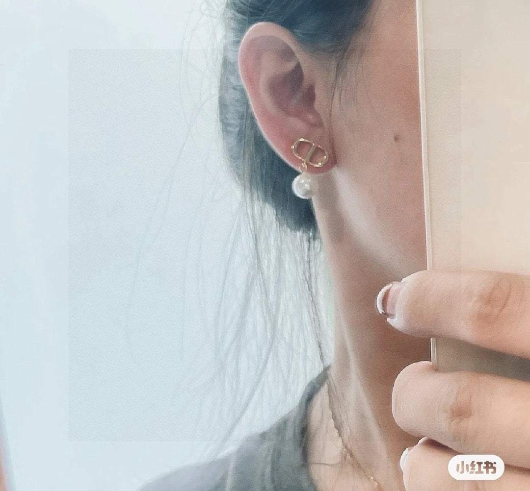 Martin Graham stud earrings in polished metal-tone – close-up detail