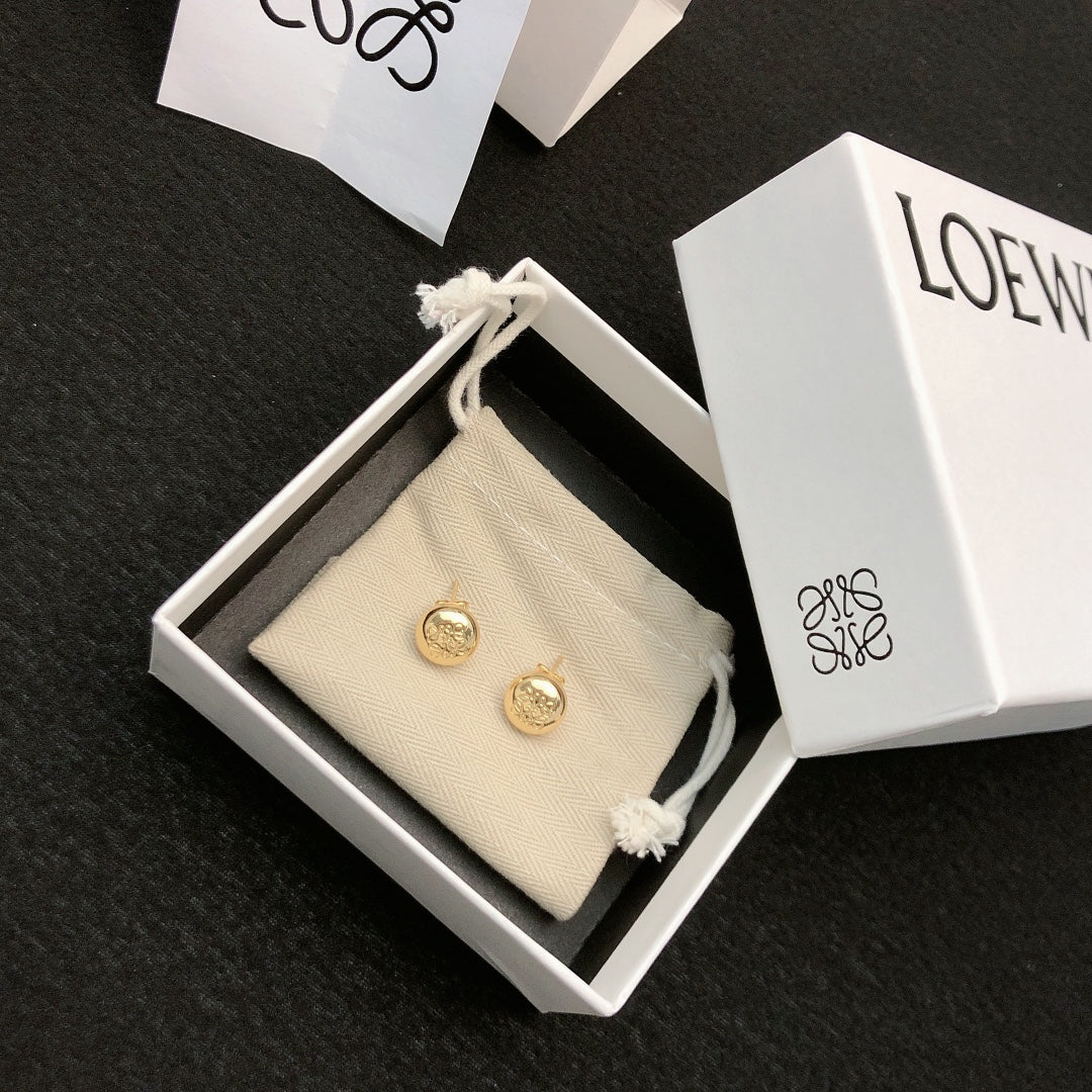 Martin Graham stud earrings in polished metal-tone – close-up detail