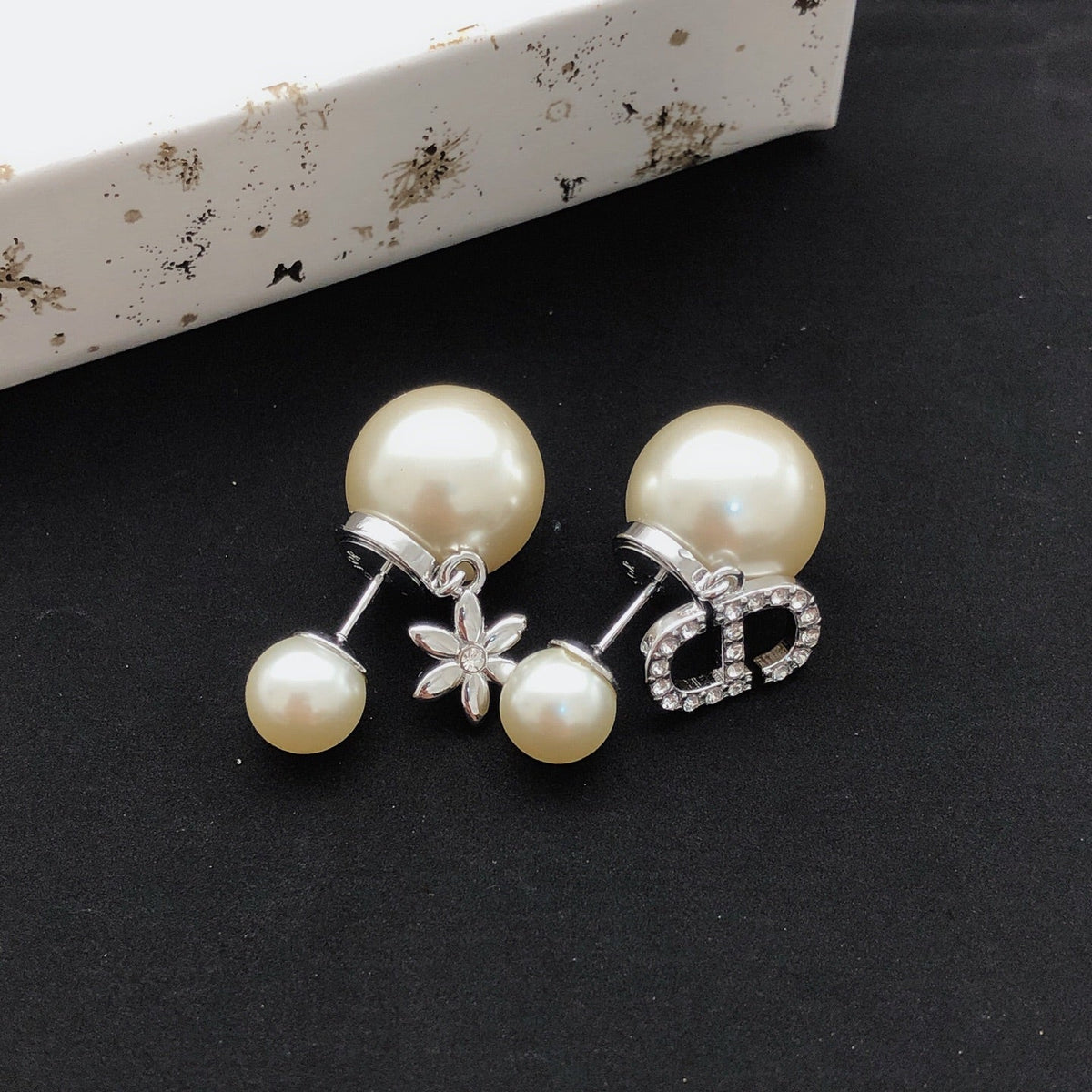 Martin Graham stud earrings in polished metal-tone – close-up detail