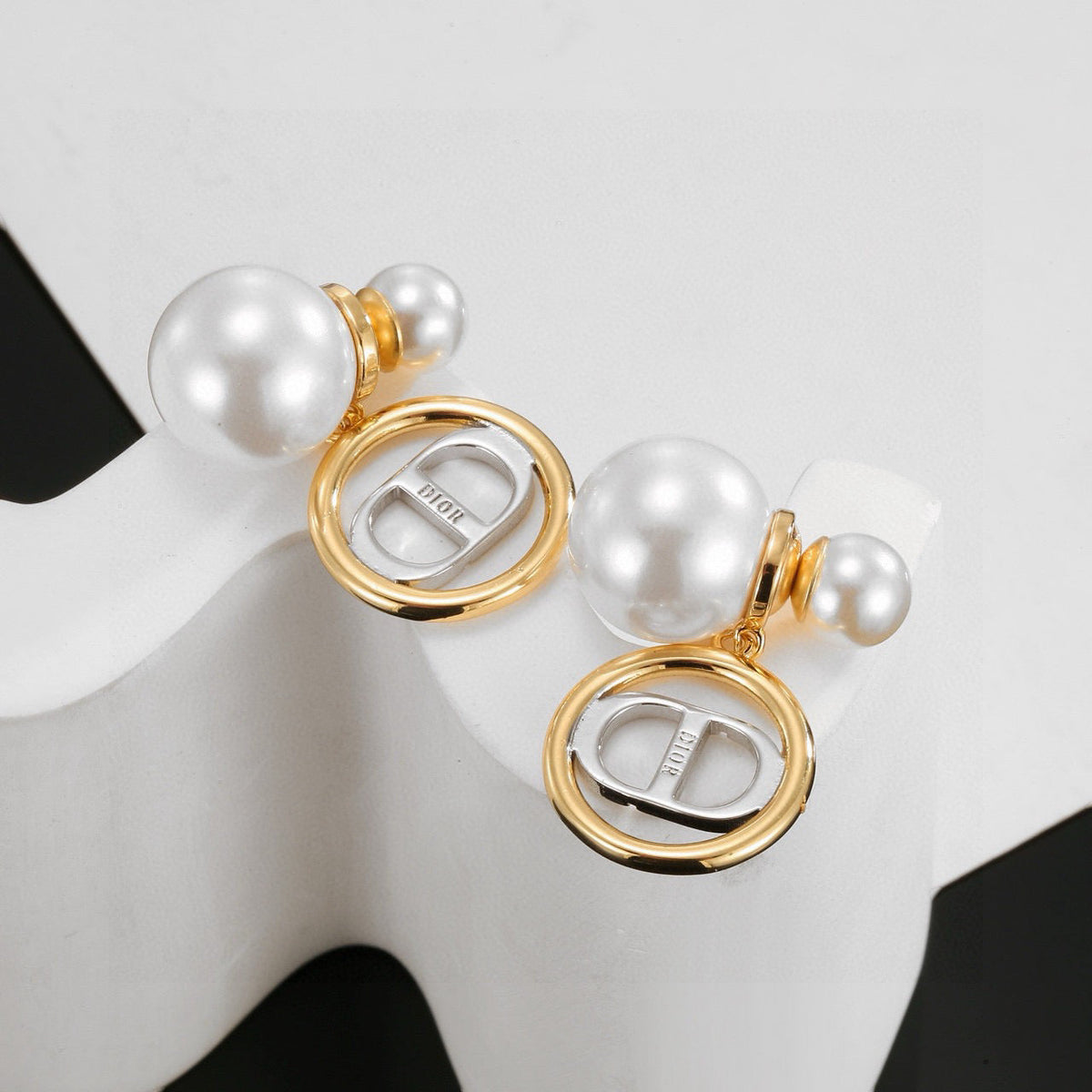 Martin Graham stud earrings in polished metal-tone – close-up detail
