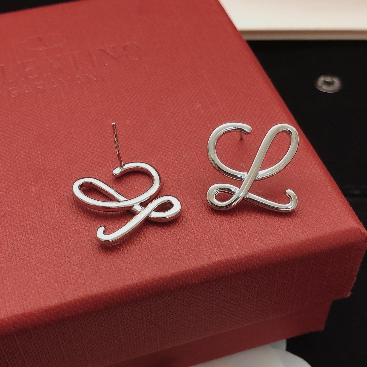 Martin Graham stud earrings in polished metal-tone – close-up detail