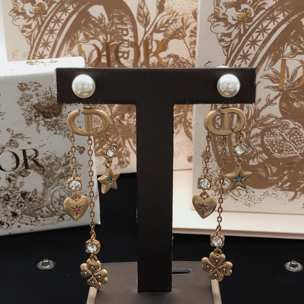 Martin Graham stud earrings in polished metal-tone – close-up detail