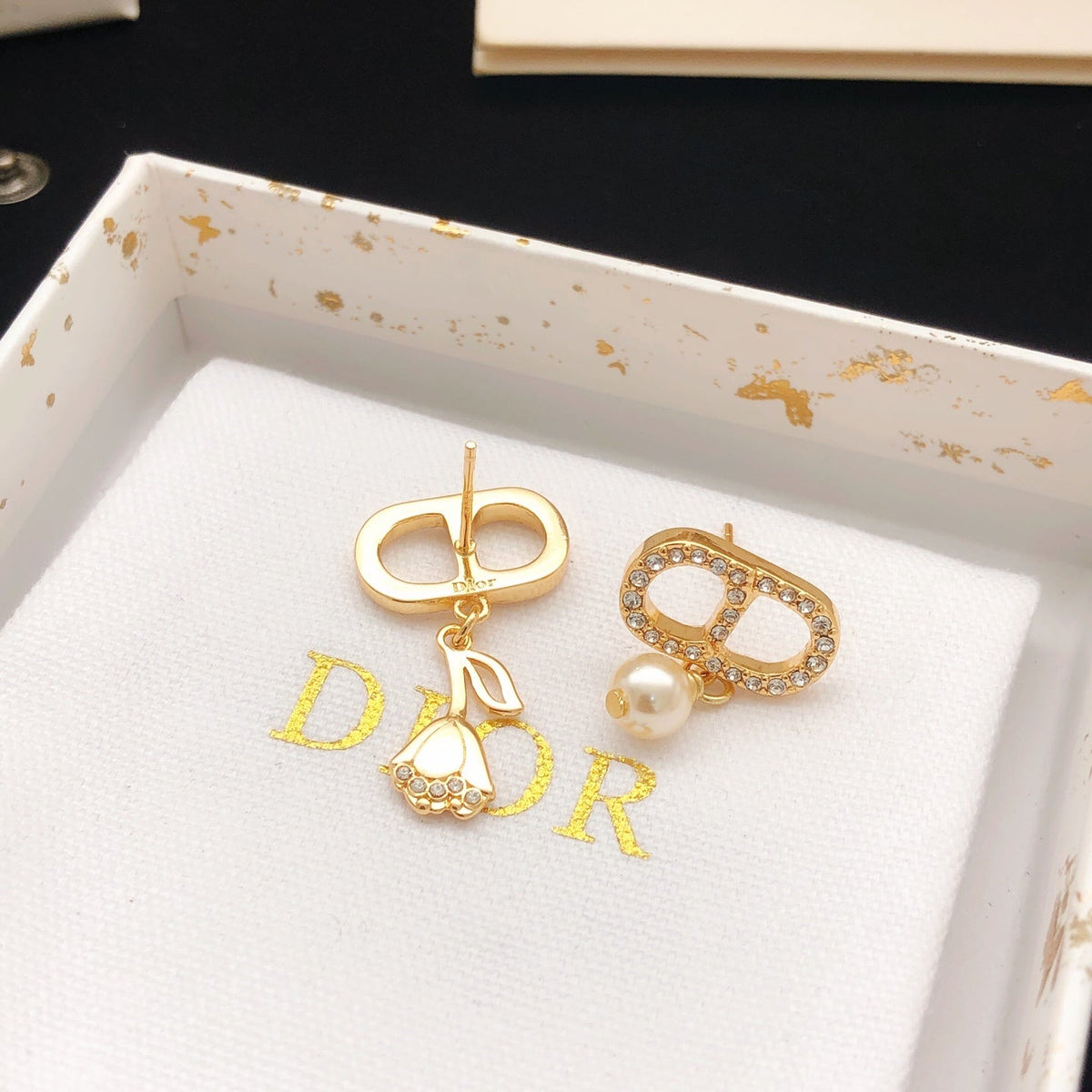 Martin Graham stud earrings in polished metal-tone – close-up detail