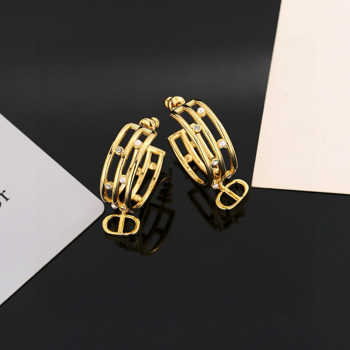 Martin Graham stud earrings in polished metal-tone – close-up detail