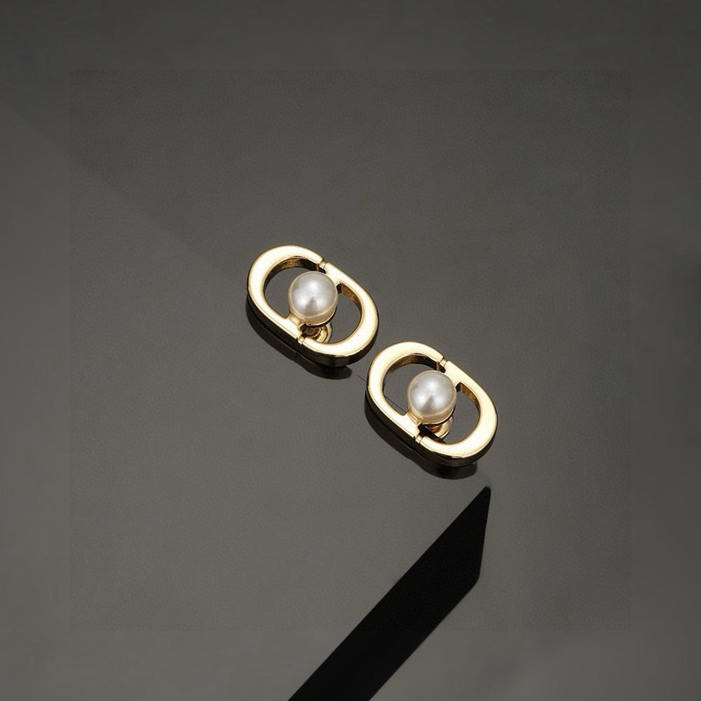Martin Graham stud earrings in polished metal-tone – close-up detail
