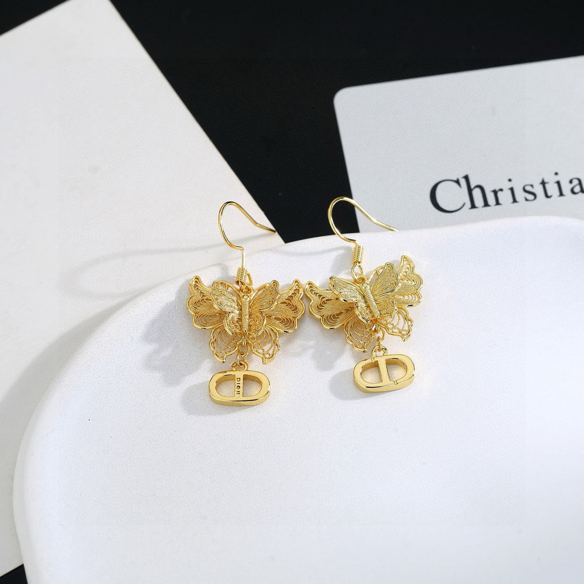 Martin Graham stud earrings in polished metal-tone – close-up detail