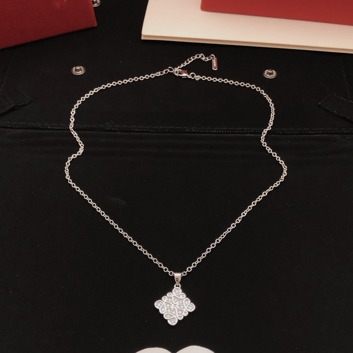 Martin Graham pendant necklace in polished metal-tone – close-up detail