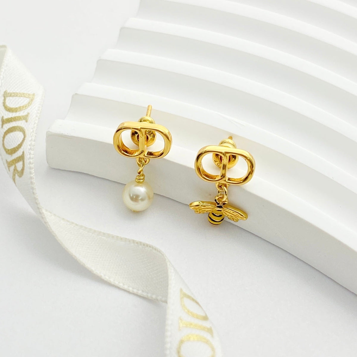 Martin Graham stud earrings in polished metal-tone – close-up detail