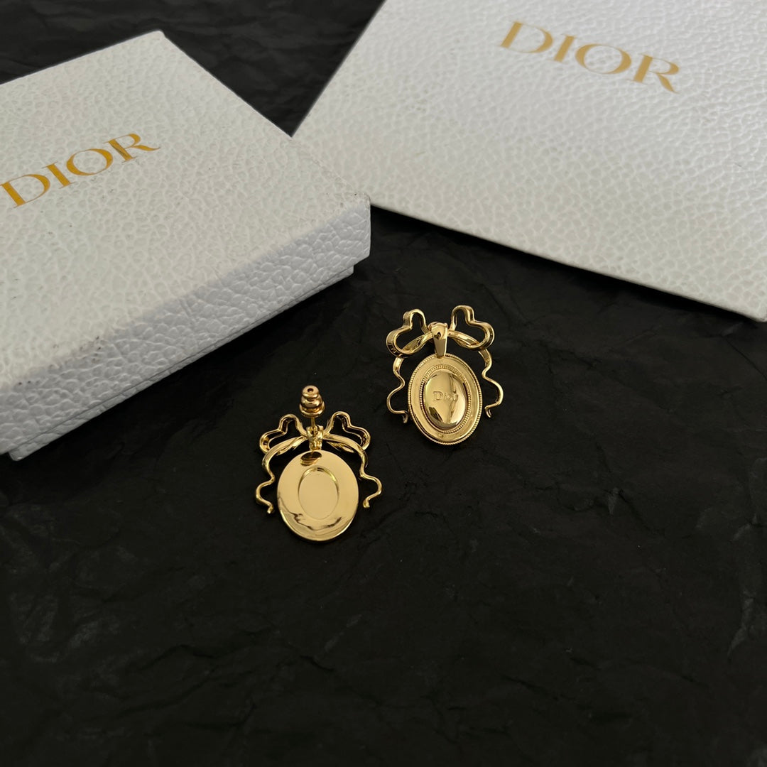 Martin Graham stud earrings in polished metal-tone – close-up detail
