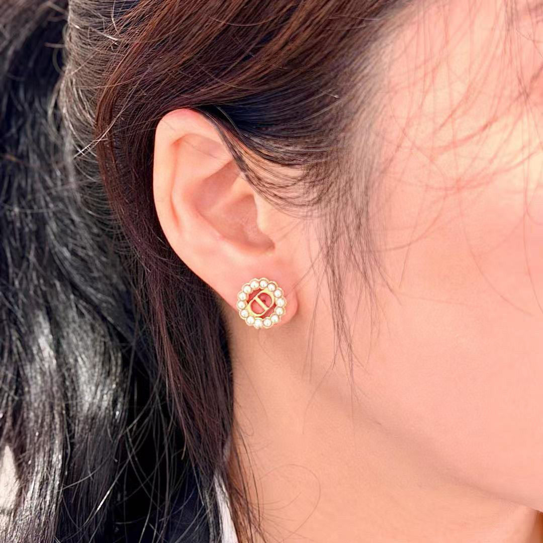 Martin Graham stud earrings in polished metal-tone – close-up detail