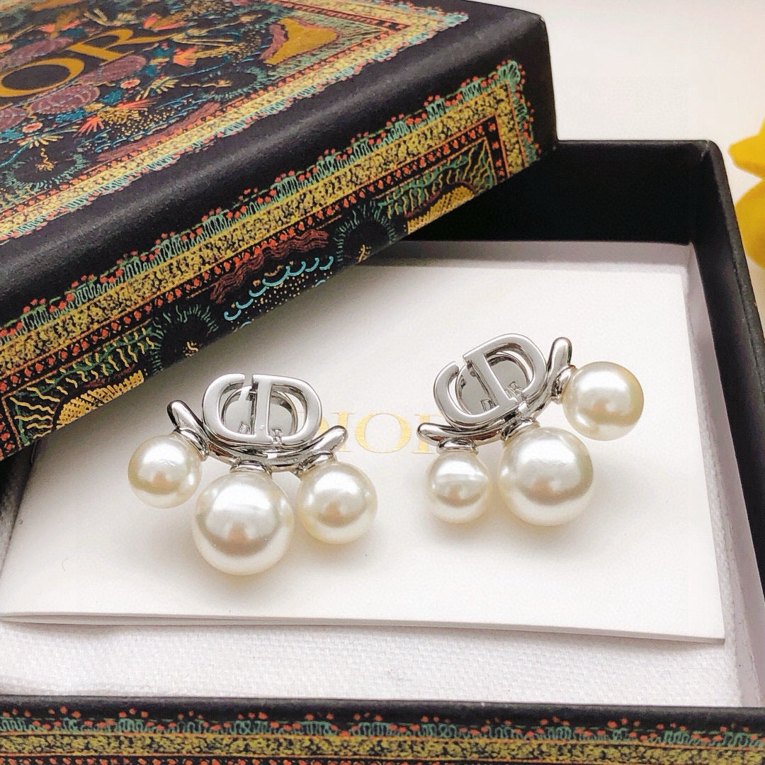 Martin Graham stud earrings in polished metal-tone – close-up detail