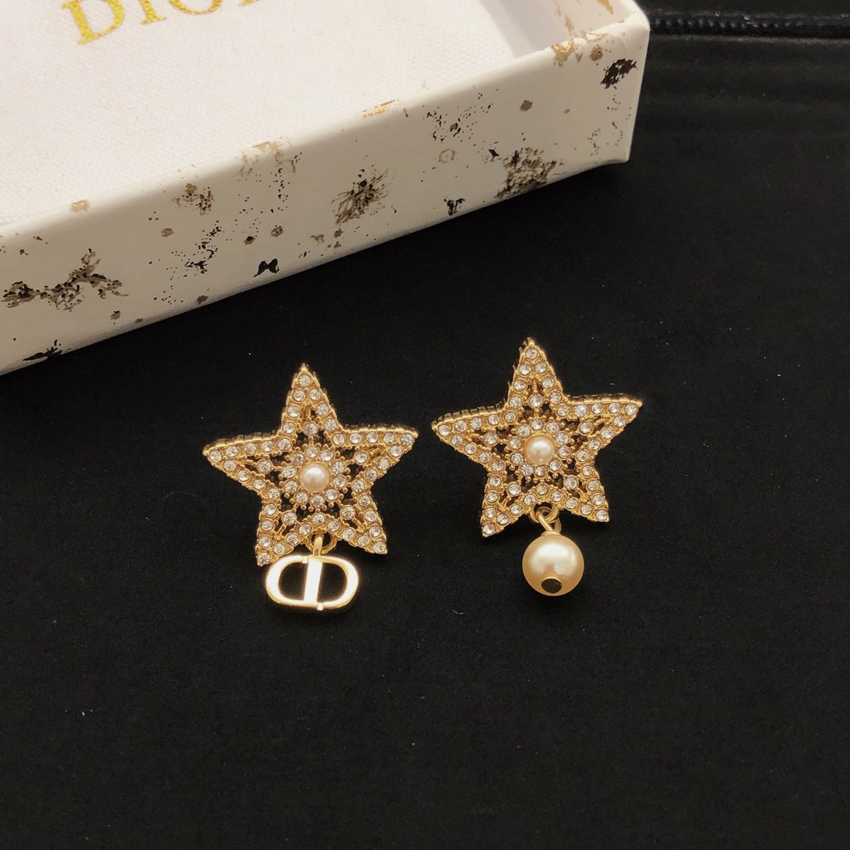 Martin Graham stud earrings in polished metal-tone – close-up detail
