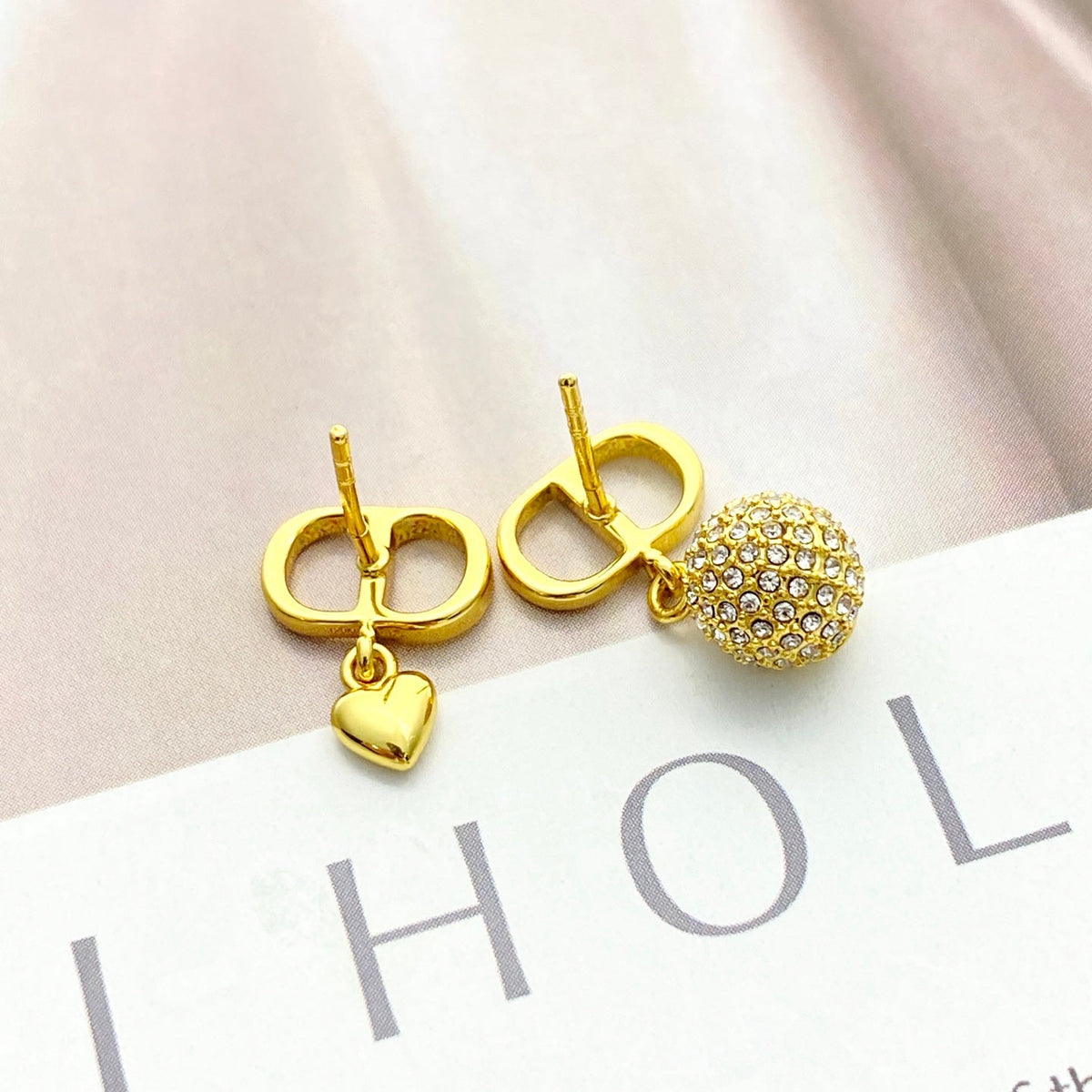 Martin Graham stud earrings in polished metal-tone – close-up detail