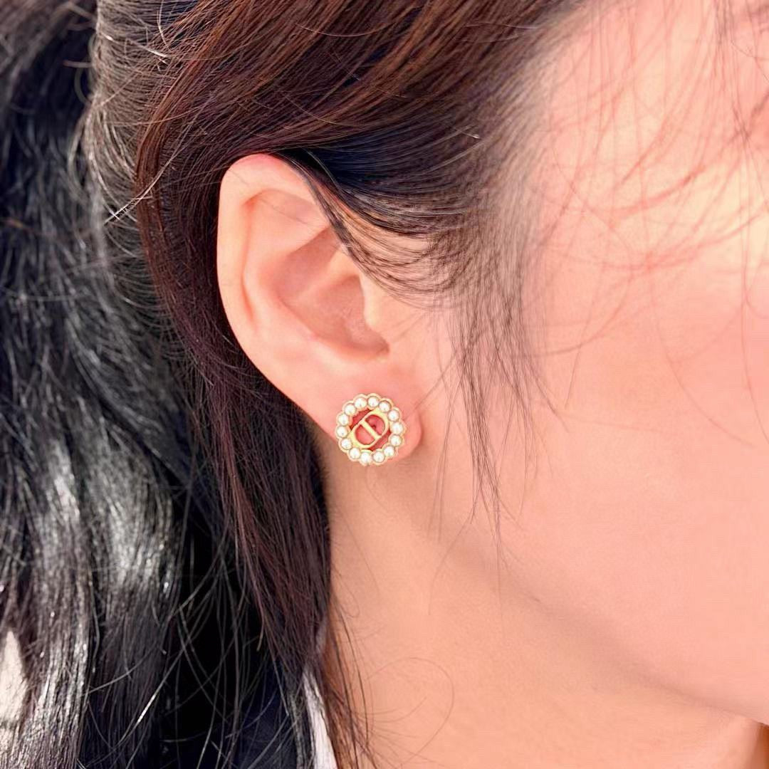 Martin Graham stud earrings in polished metal-tone – close-up detail