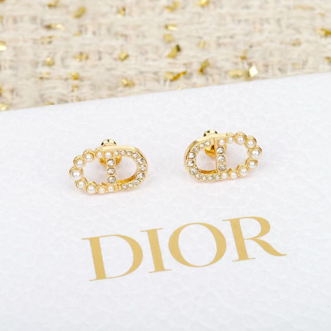 Martin Graham stud earrings in polished metal-tone – close-up detail