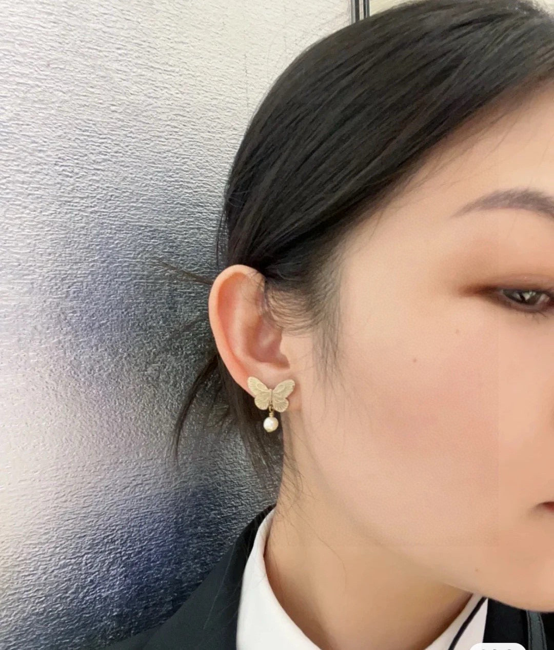 Martin Graham stud earrings in polished metal-tone – close-up detail