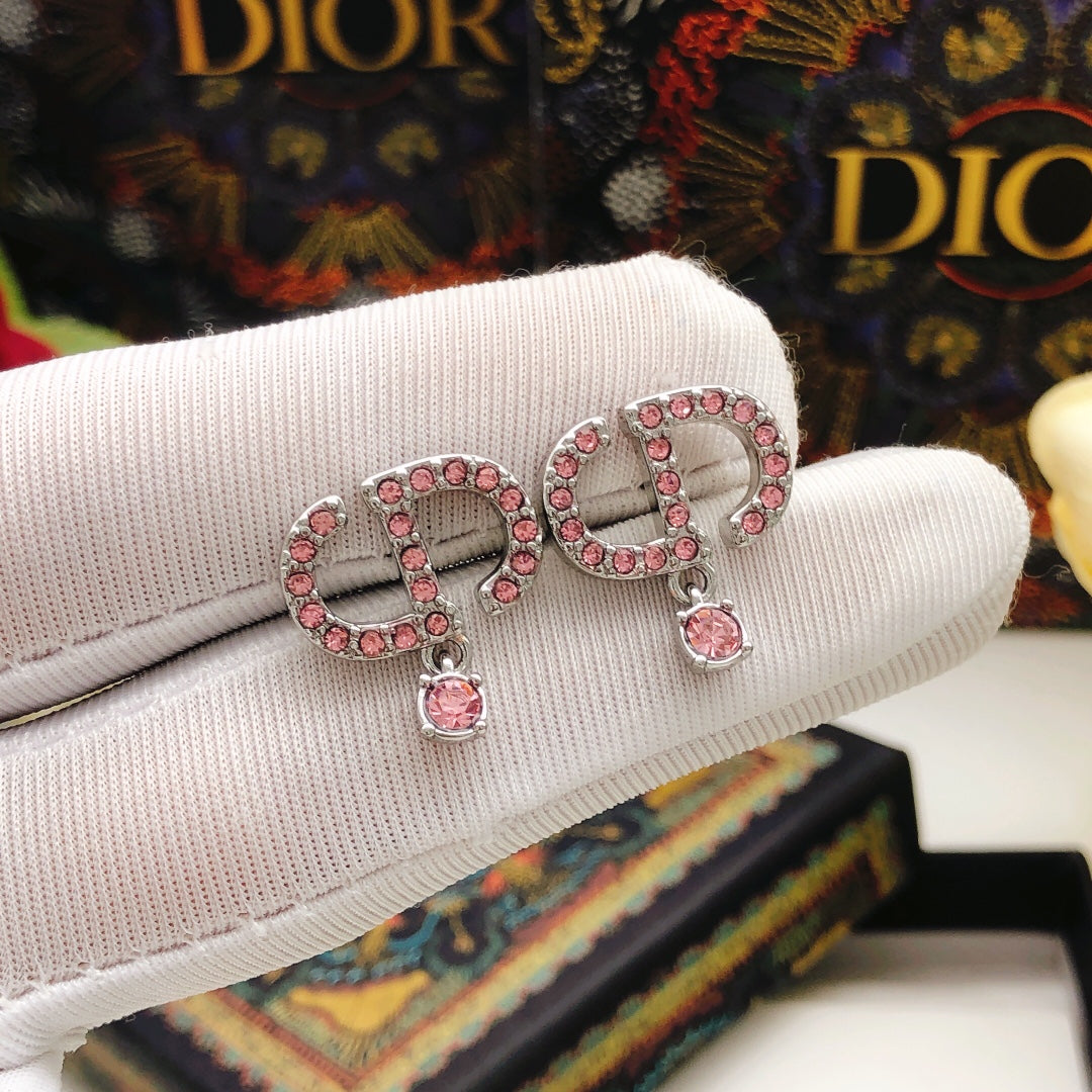 Martin Graham stud earrings in polished metal-tone – close-up detail