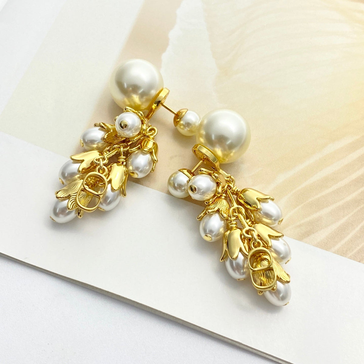 Martin Graham stud earrings in polished metal-tone – close-up detail