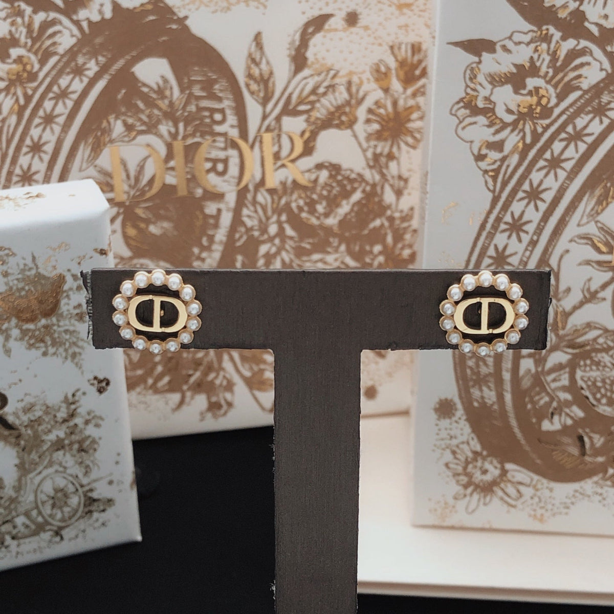 Martin Graham stud earrings in polished metal-tone – close-up detail