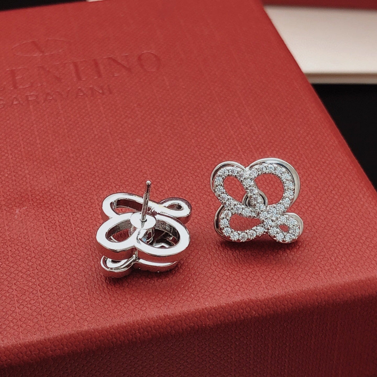 Martin Graham stud earrings in polished metal-tone – close-up detail