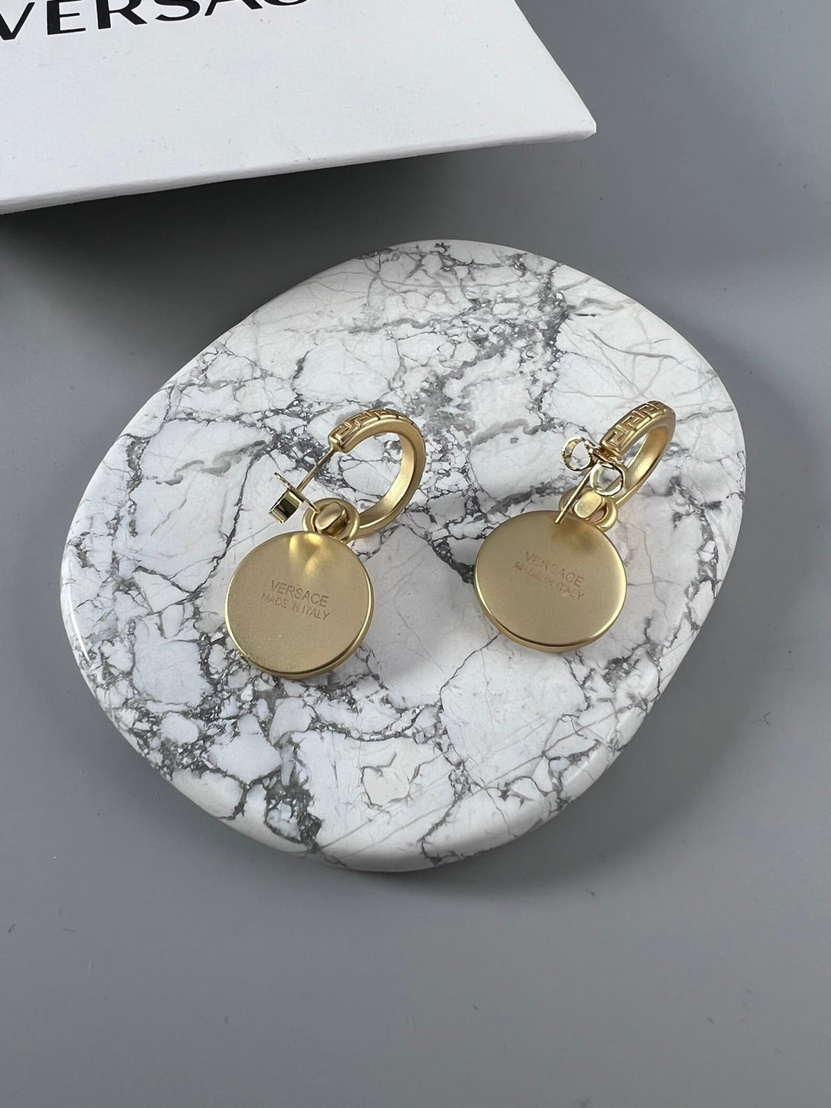 Martin Graham stud earrings in polished metal-tone – close-up detail